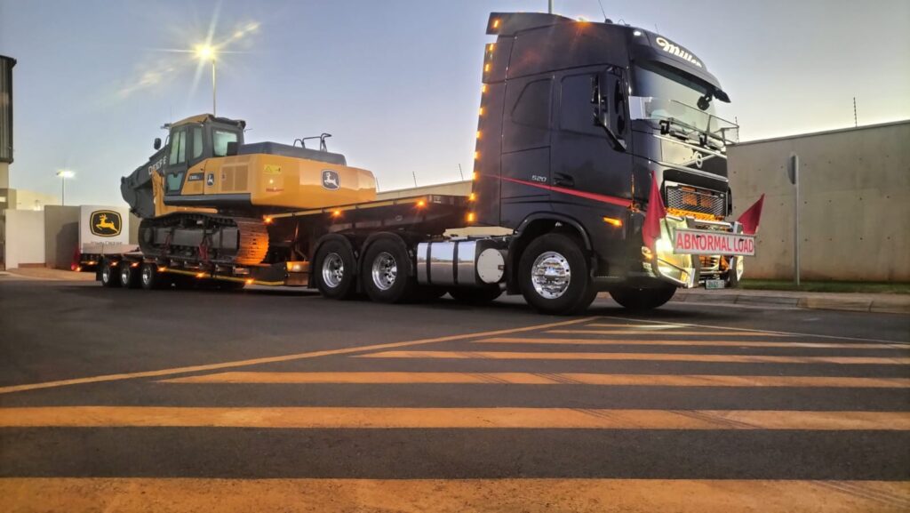 Lowbed truck transporting large agricultural tractor