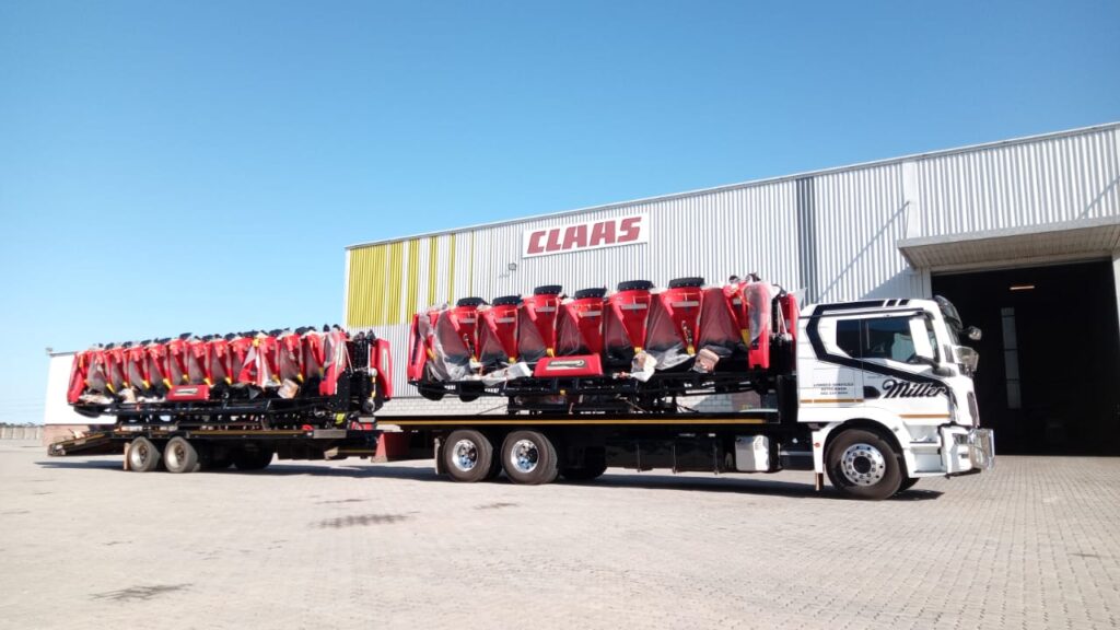 Lowbed truck transporting large agricultural tractor