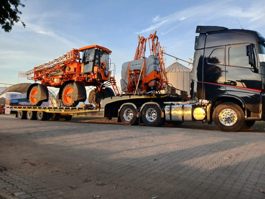 Lowbed truck transporting large agricultural tractor