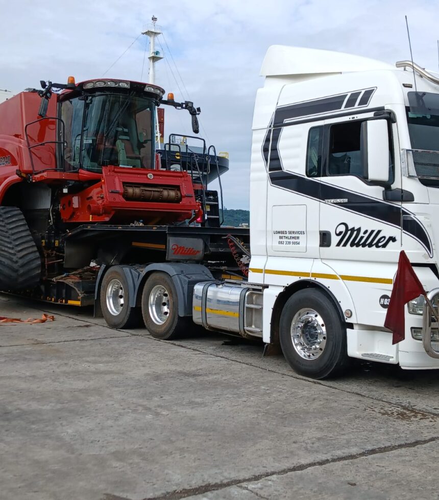 Crane truck lifting agricultural implement