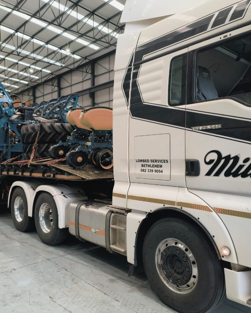 Crane truck lifting agricultural implement